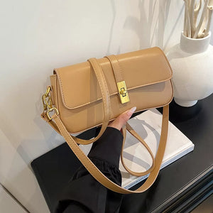 Taupe rectangular crossbody bag with gold clasp and adjustable strap