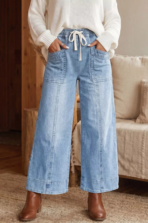 wide-leg jeans in light blue featuring drawstring waist and wide-leg fit