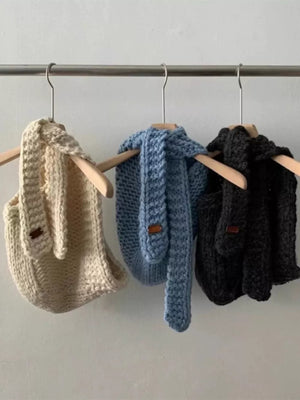 Cozy wool earflap beanies in off-white, blue, and black, with ear details.