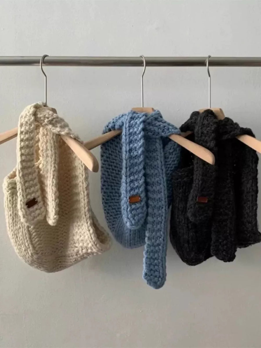 Cozy wool earflap beanies in off-white, blue, and black, with ear details.