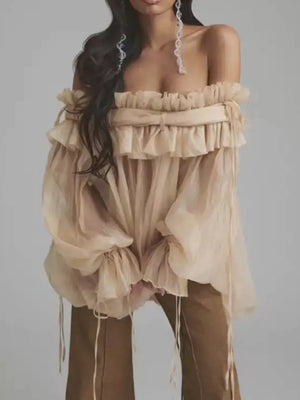 Romantic off-shoulder ruffled blouse in champagne color with billowy sleeves and adjustable ties.
