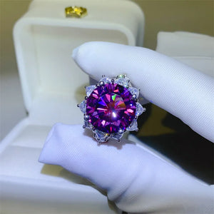 Amethyst sunburst moissanite cocktail ring with halo setting and deep purple center stone.