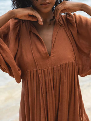 Elegant tie-neck midi dress in Amber with puff sleeves and gathered skirt.