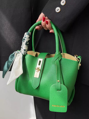 Green crossbody bag with scarf detail and gold hardware.