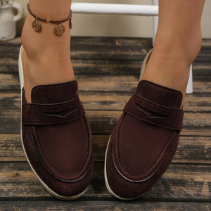 Brown textured round toe slip-on loafers with decorative strap detail.