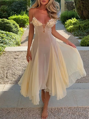 Sheer yellow slip dress with floral bust detail and lace-up front.