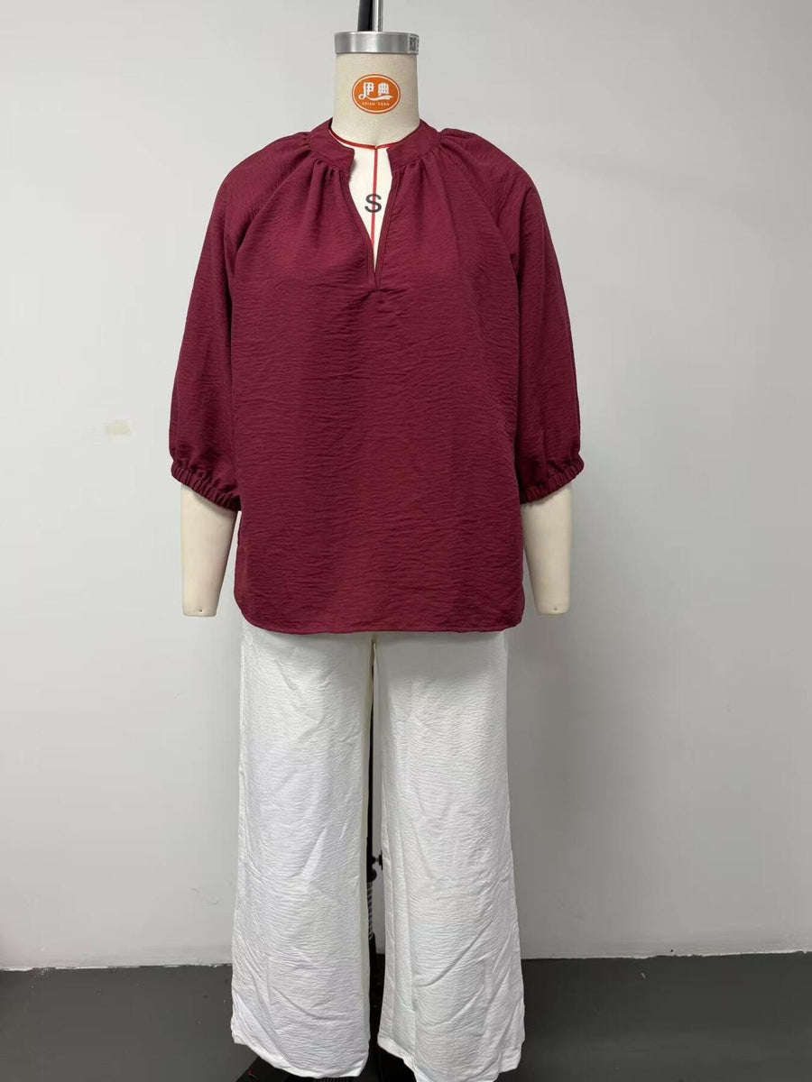 100% polyester Care instructions: Machine wash cold blouse and wide-leg pants set in ivory with relaxed silhouette