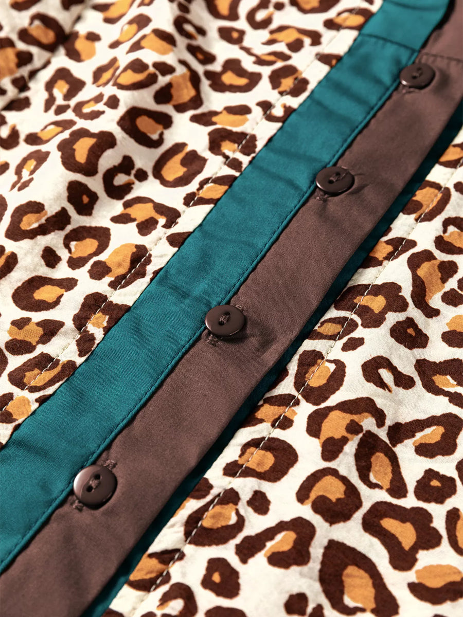 Leopard print button-down shirt with teal and brown paneling and dark buttons.