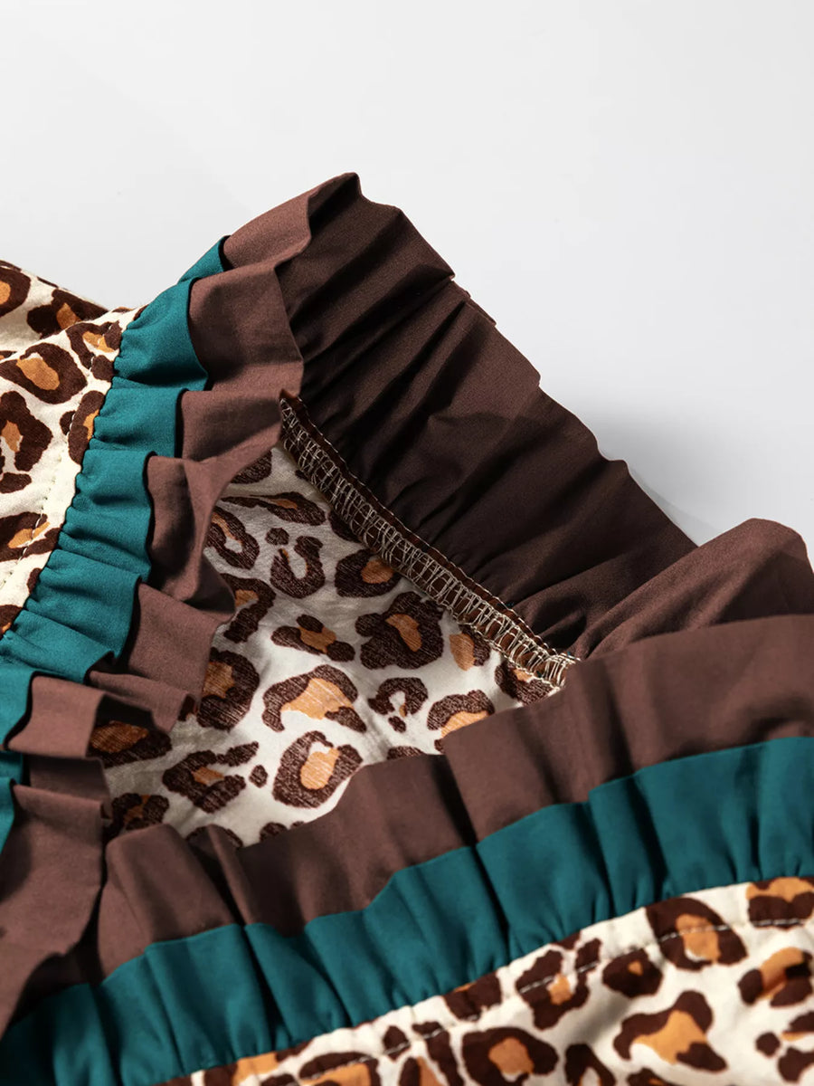 Leopard print button-down shirt with brown and teal frilled trim detail.
