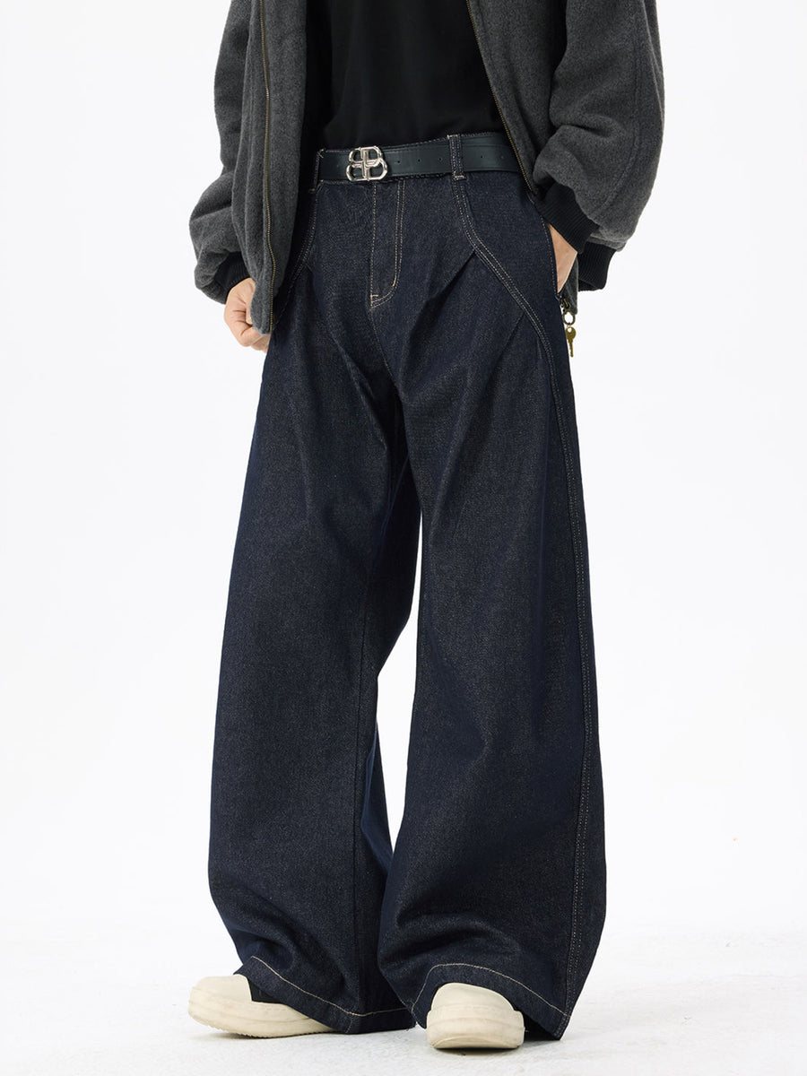 Dark wash denim jeans with exaggerated wide legs and contrast stitching.