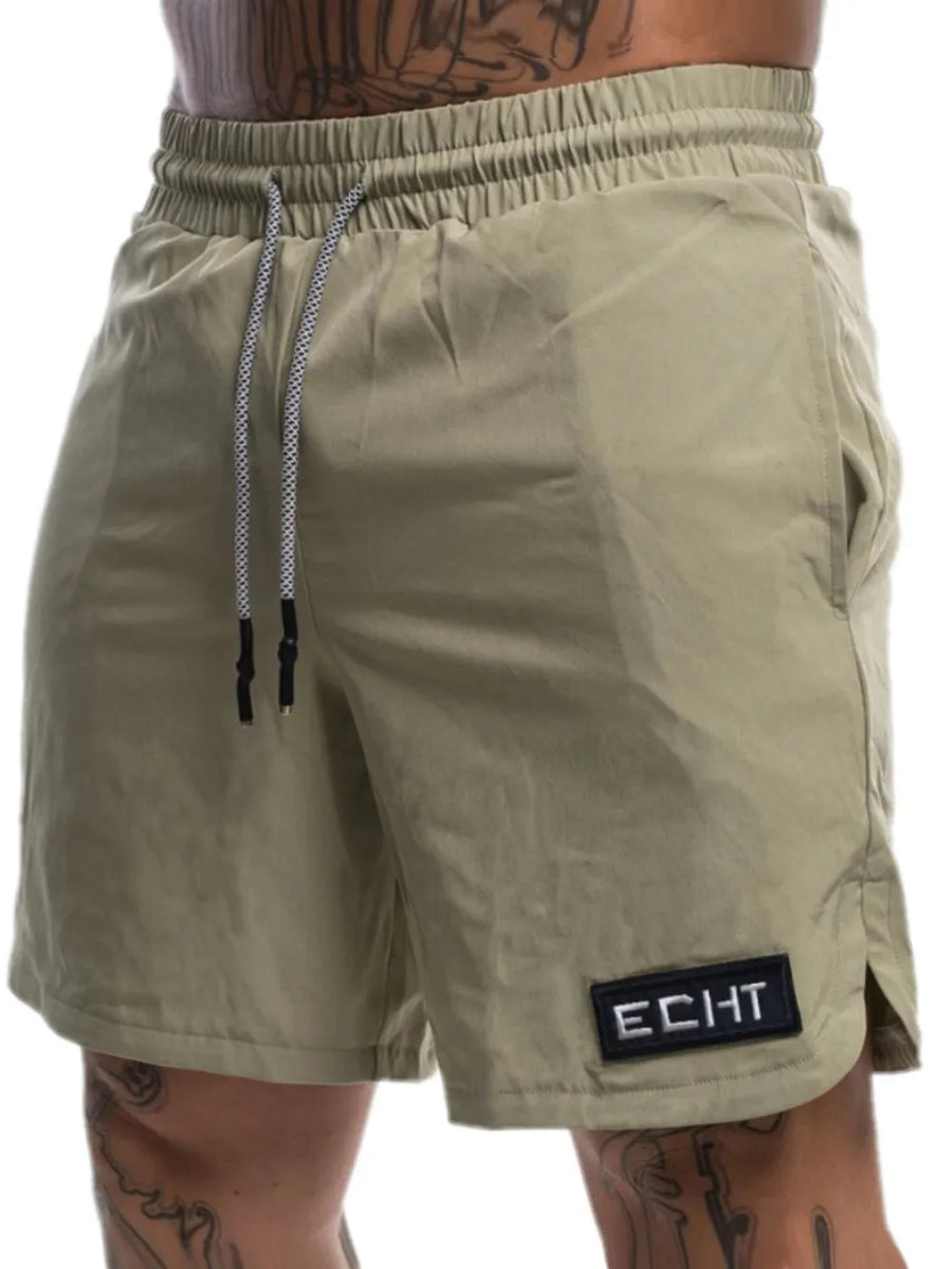 Khaki performance drawstring shorts with logo patch and side vents.