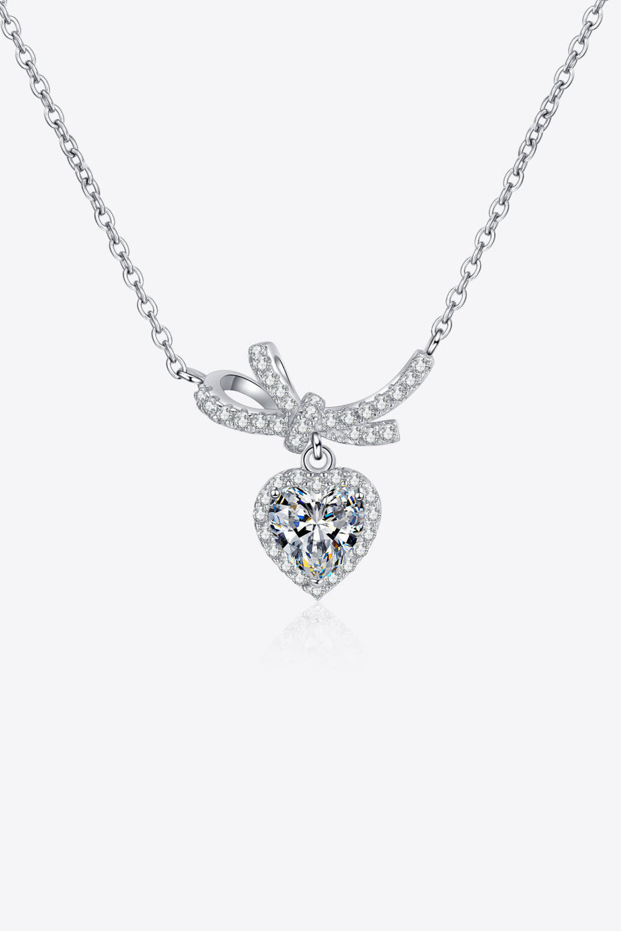 Silver necklace with cubic zirconia heart pendant and bow accent