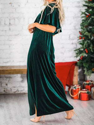 Green velvet maxi dress with flutter sleeves and cinched waist.