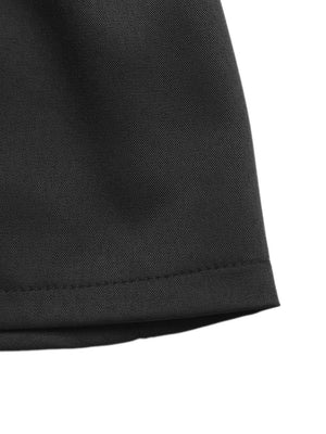 Black high-waisted pleated chino shorts with a decorative button detail.