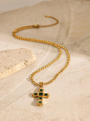 Gold cross pendant necklace with green zirconia on a figaro chain