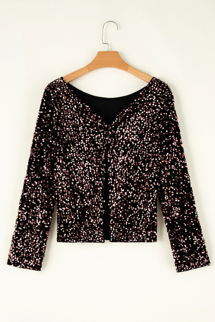 Black sequin backless blouse with long sleeves and a V-neckline.