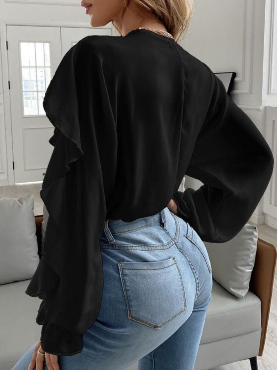 Black Flutter Chic V-Neck Blouse with ruffled sleeves and long sleeves.