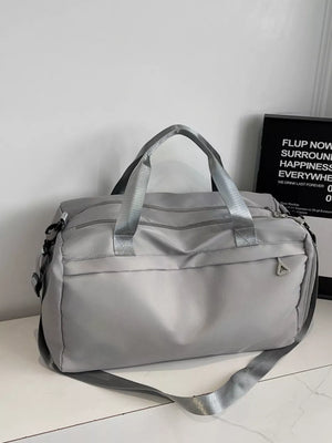 Gray nylon duffel bag with multiple zippered pockets and adjustable shoulder strap.