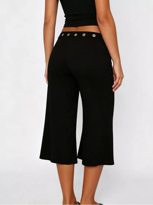 Black flared hem capri pants with button detail at the waist