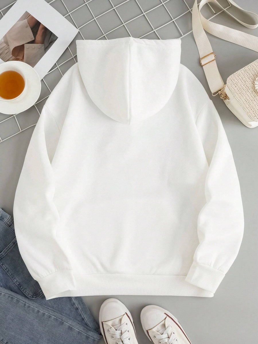 White oversized hoodie with pouch pocket and cuffed sleeves, styled casually.