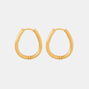 Gold oval hoop earrings with pearl drop detail