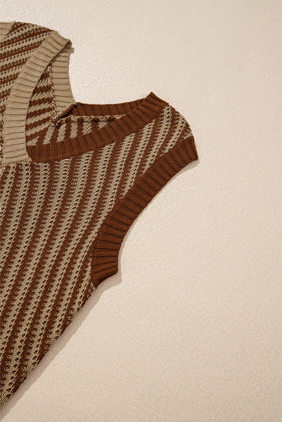 Brown and tan chevron knit vest with a square neckline and open knit detail.