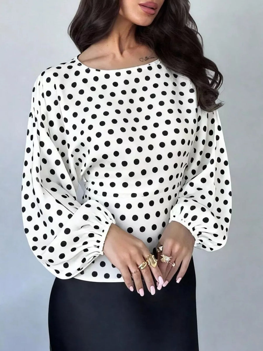 black blouse featuring elastic cuffs and polka dot