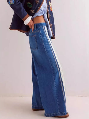 cream wide-leg jeans featuring side snaps and striped