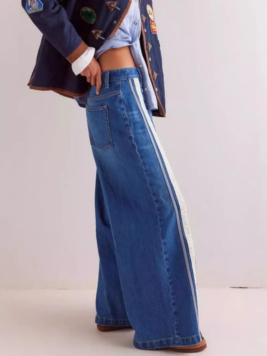 cream wide-leg jeans featuring side snaps and striped
