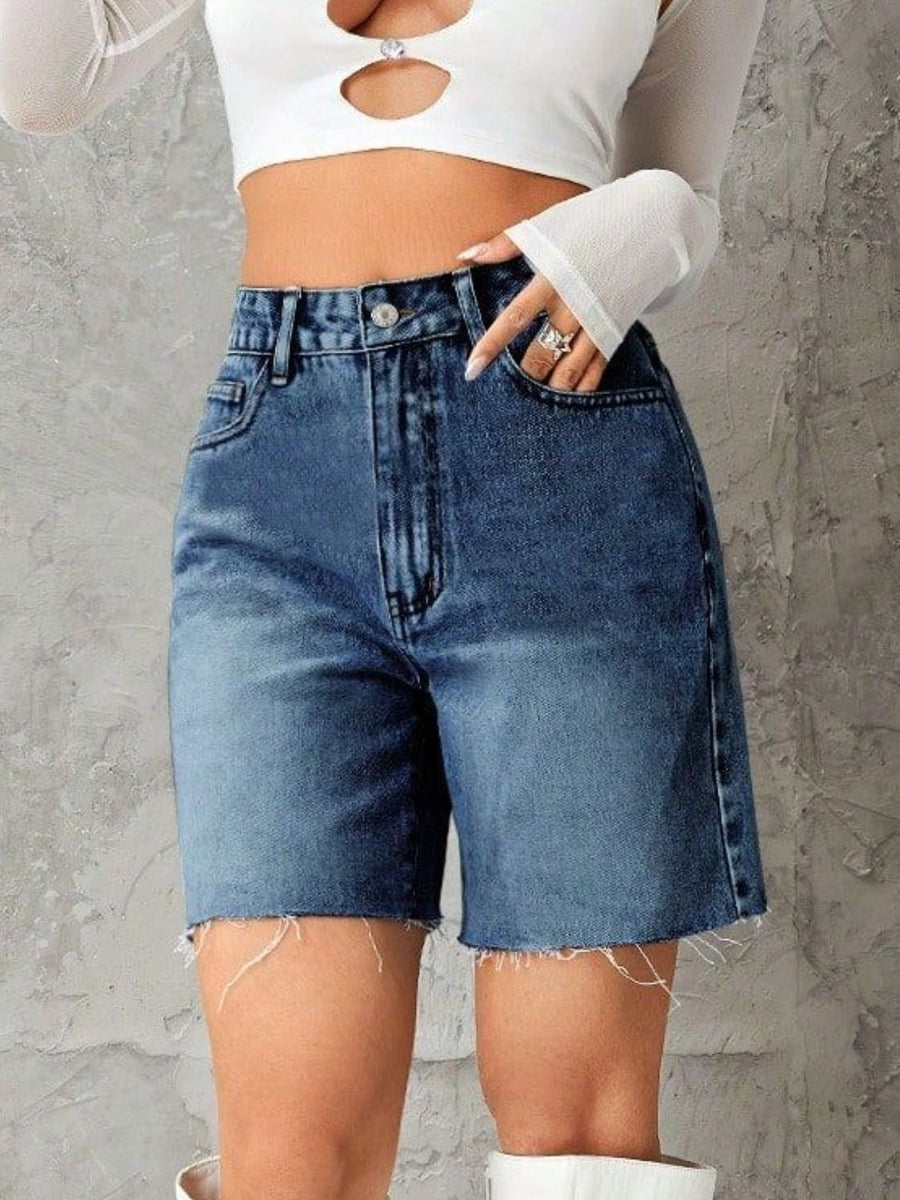 High-waisted denim bermuda shorts in medium blue with frayed hem.