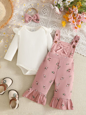 white overalls featuring buttoned straps and ditsy floral
