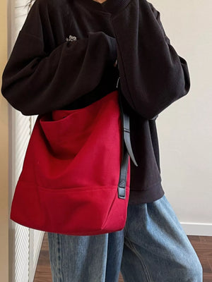 Red hobo bag with adjustable strap and black leather accents.
