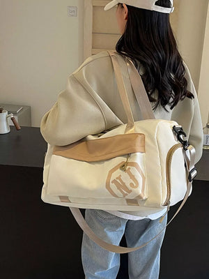 Off-white Oxford cloth travel duffel bag with tan accents and NJ logo detail.