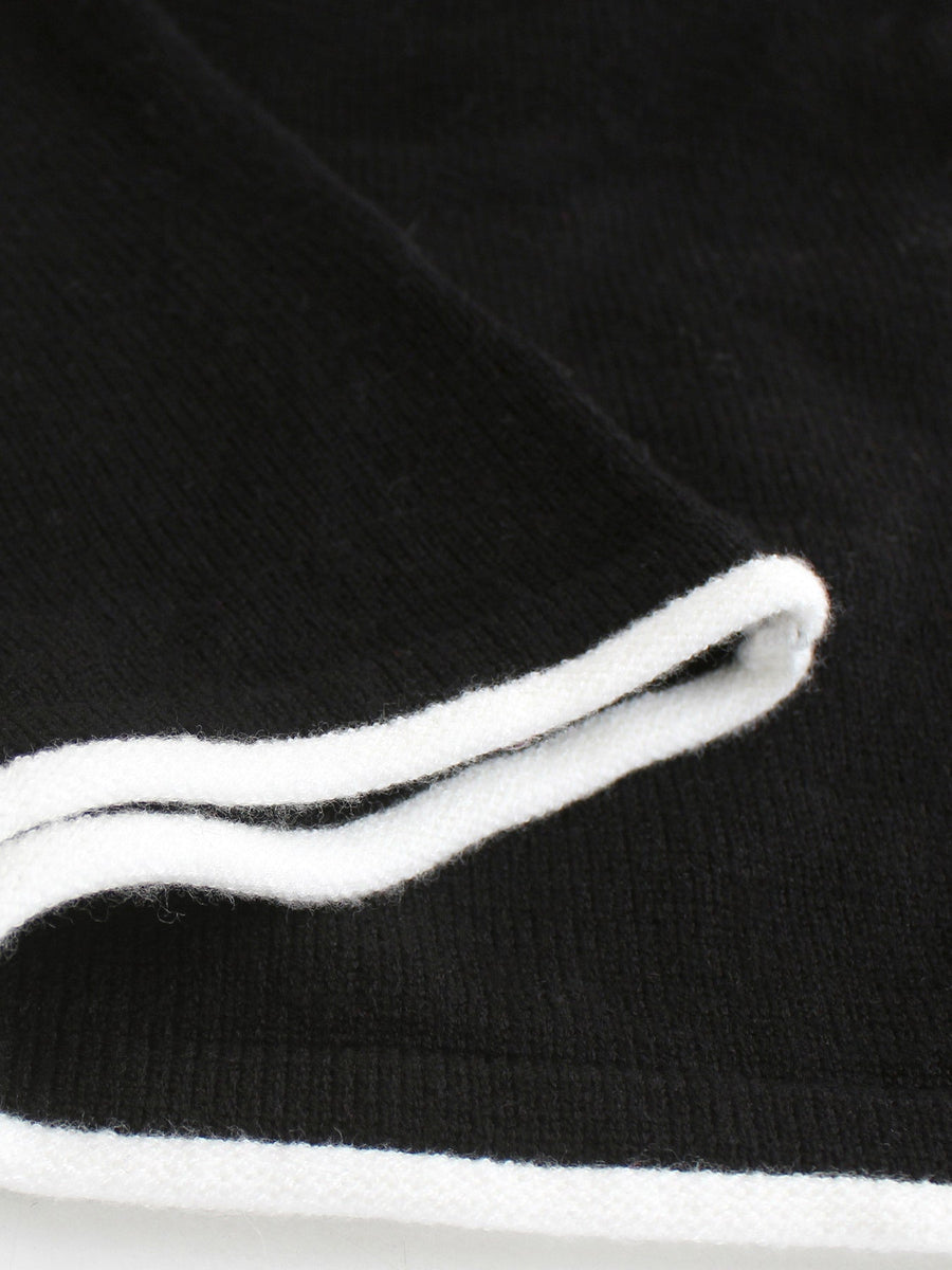 Black maxi dress detail with white ruffled trim neckline