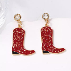 gold earrings featuring dangle and ornate