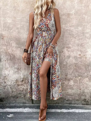 Multicolor paisley print maxi dress with cinched waist and dramatic slit.