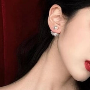 Pearl stud earrings with a crown-inspired crystal jacket.