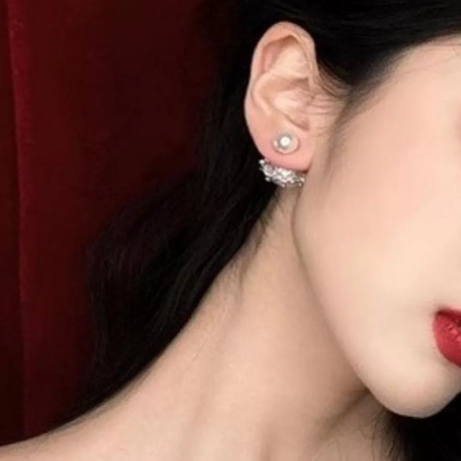 Pearl stud earrings with a crown-inspired crystal jacket.