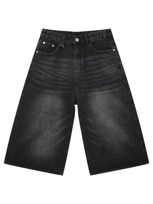 Black wide-leg distressed denim culottes with button fly and metal ring detail.