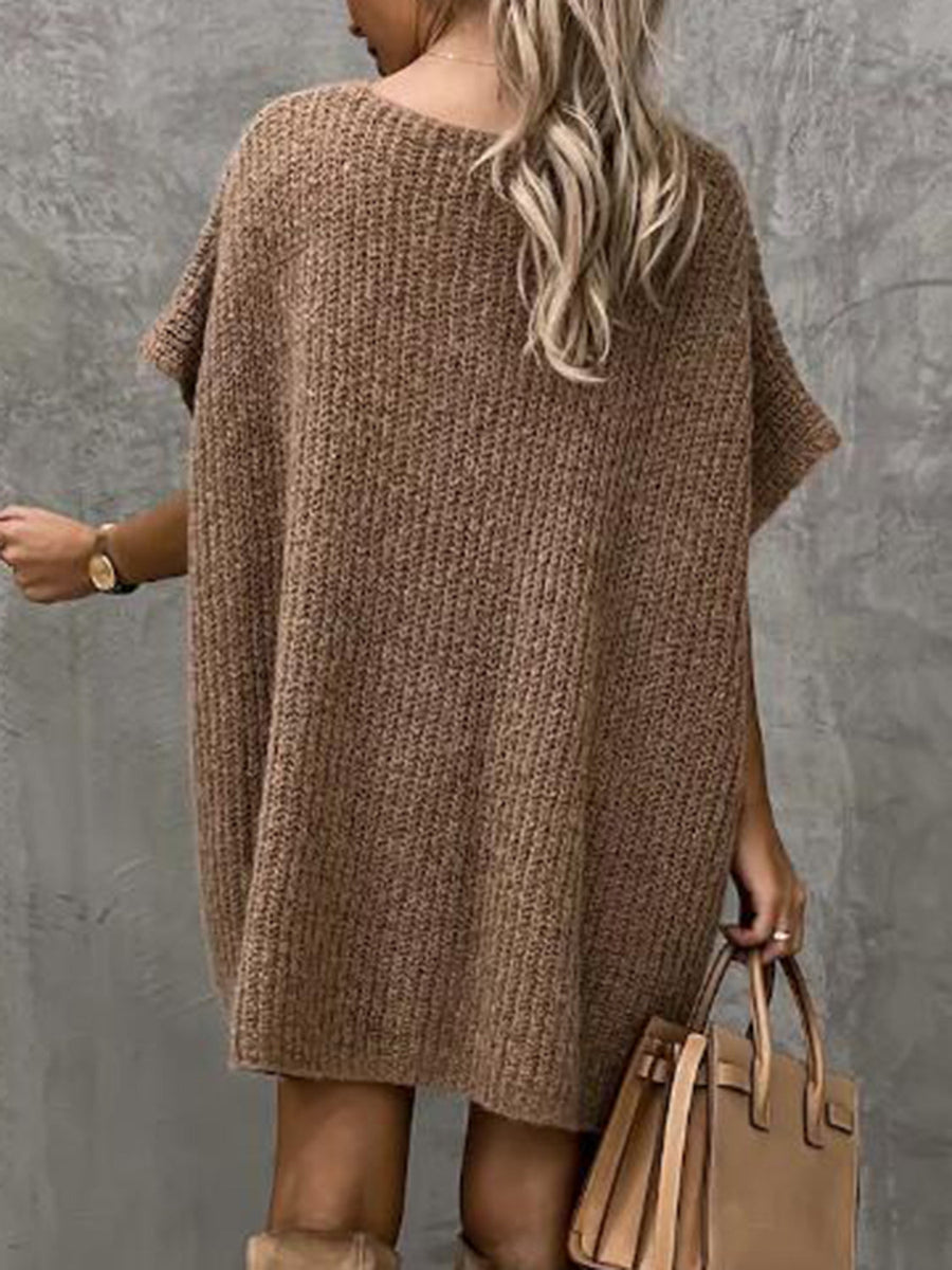 Mocha knit cocoon dress with short sleeves and a relaxed fit, styled with a handbag.
