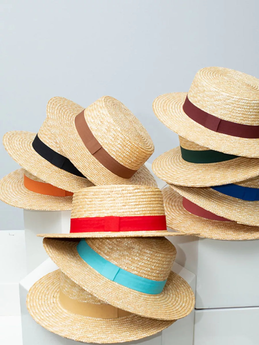Straw boater hats with colorful ribbon bands: red, blue, green, brown, black, orange, rose red, yellow