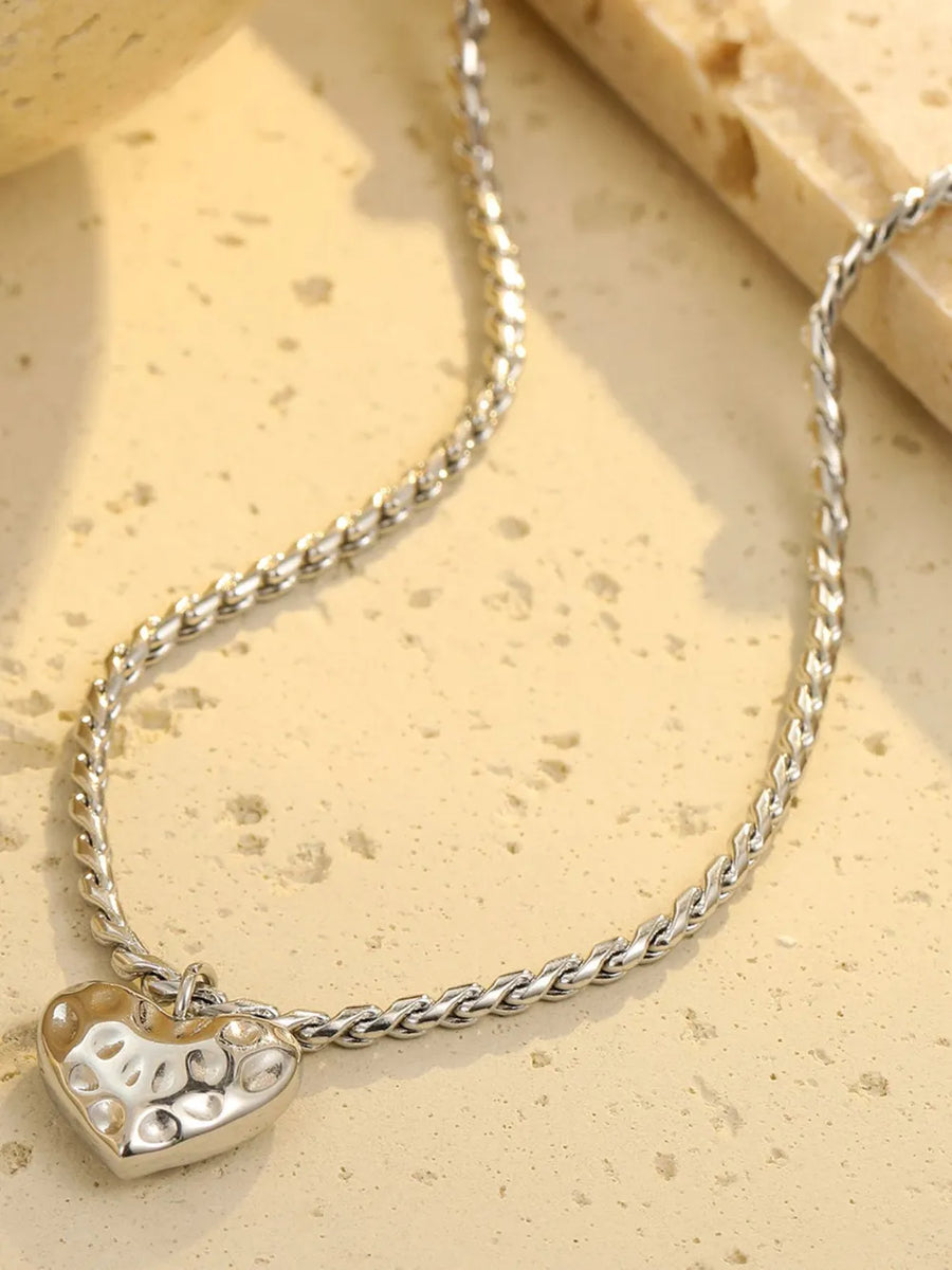 necklace in gold with heart pendant and collarbone length
