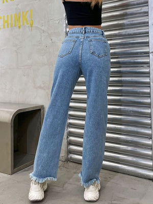 Light wash denim jeans with frayed hem and chain detail.