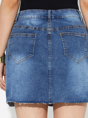 Button-front denim mini skirt in medium wash with raw hem and back pockets.