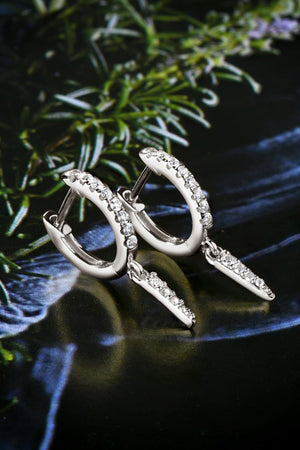 Silver pavé spike huggie earrings with dangling spike charms.