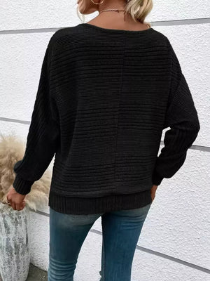 Black ribbed acrylic sweatshirt with dolman sleeves and O-ring pull detail shown from back.
