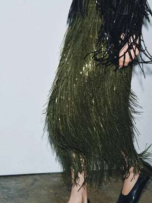 Army green sequined fringe skirt with a black sequined top.