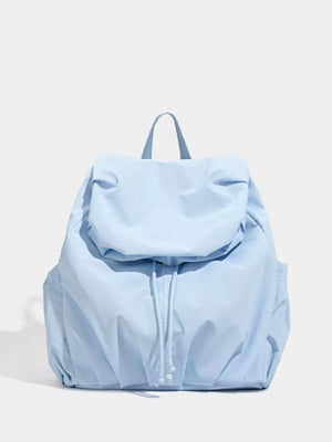 Blue nylon drawstring backpack with flap closure and side pockets