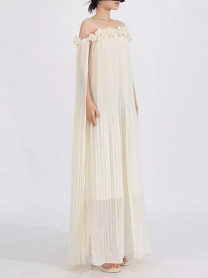 Elegant off-shoulder maxi dress in cream with floral appliques and cape sleeves.