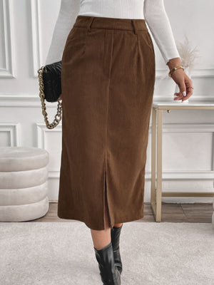 Brown corduroy midi skirt with a slit-front detail and subtle pleats.